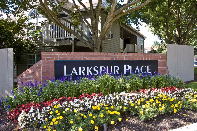 Larkspur Place Apartments: Signage at entrance displaying modern design and branding