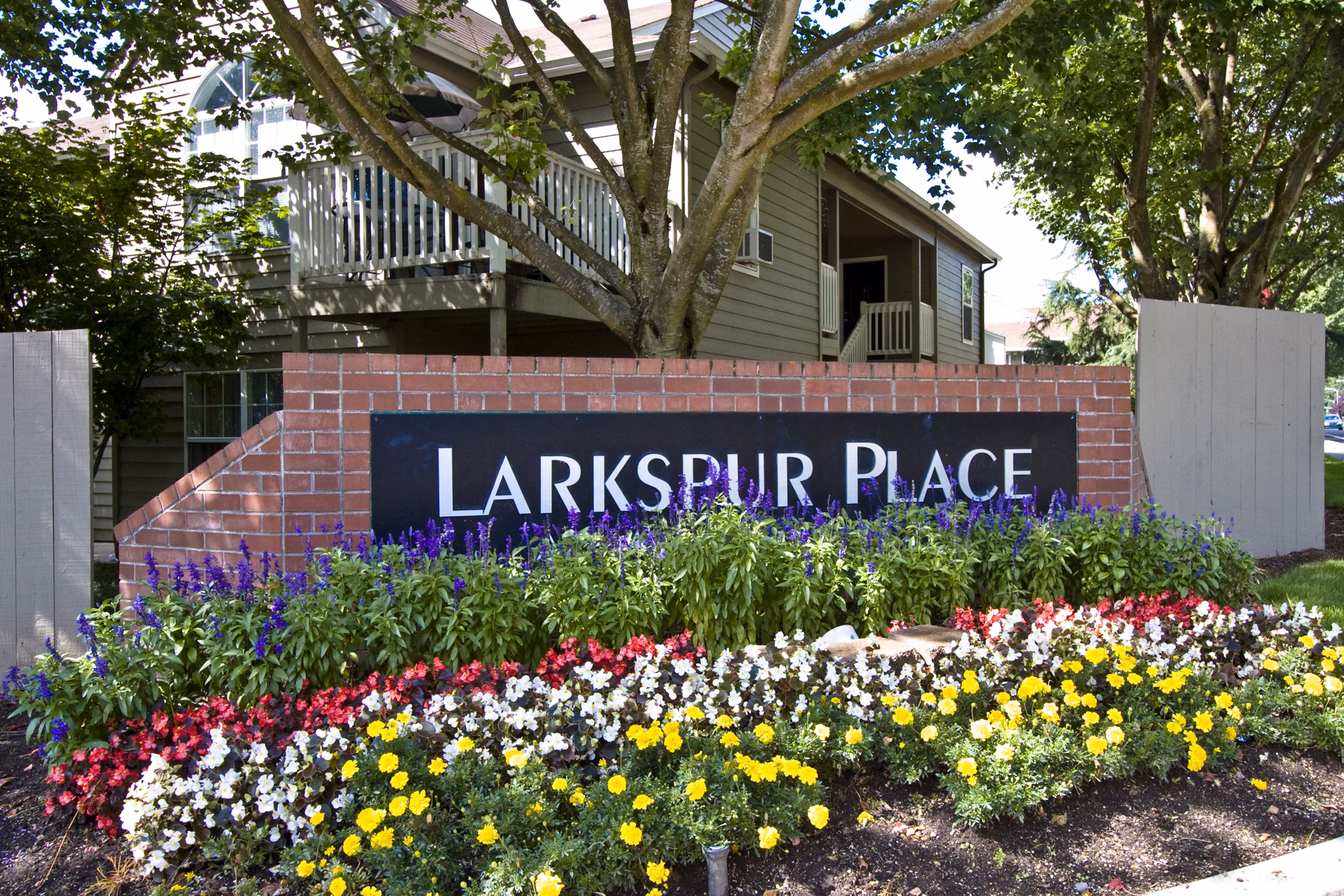 Larkspur Place Apartments: Signage at entrance displaying modern design and branding