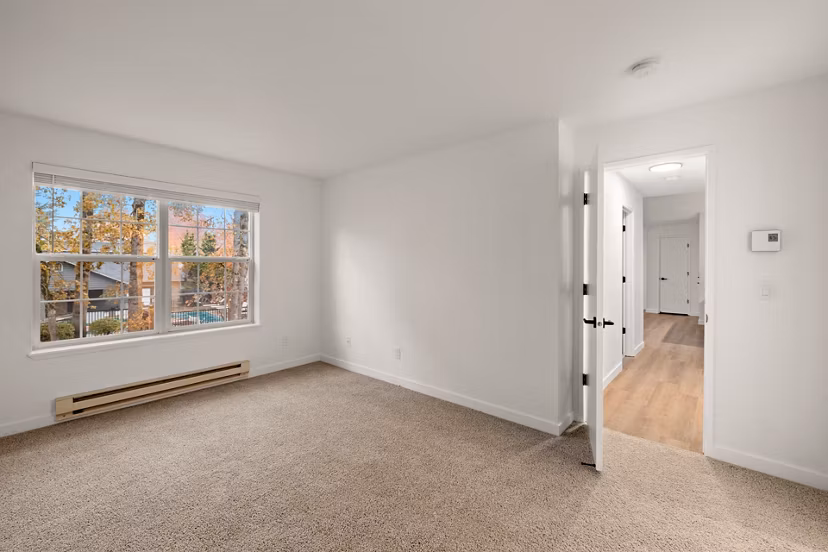 Cozy bedroom with plush bedding and natural lighting at Larkspur Place Apartments