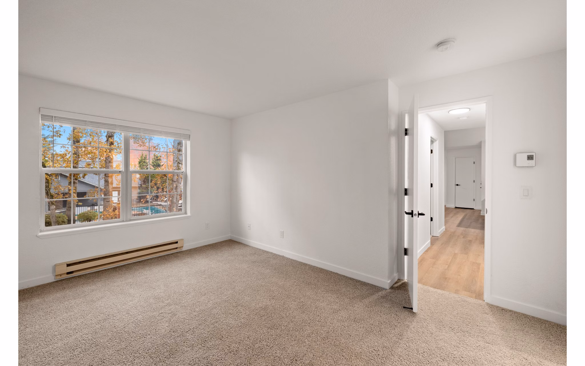 Cozy bedroom with plush bedding and natural lighting at Larkspur Place Apartments