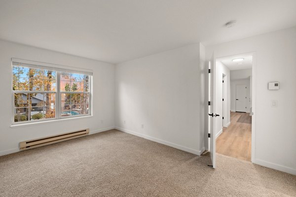 Cozy bedroom with plush bedding and natural lighting at Larkspur Place Apartments