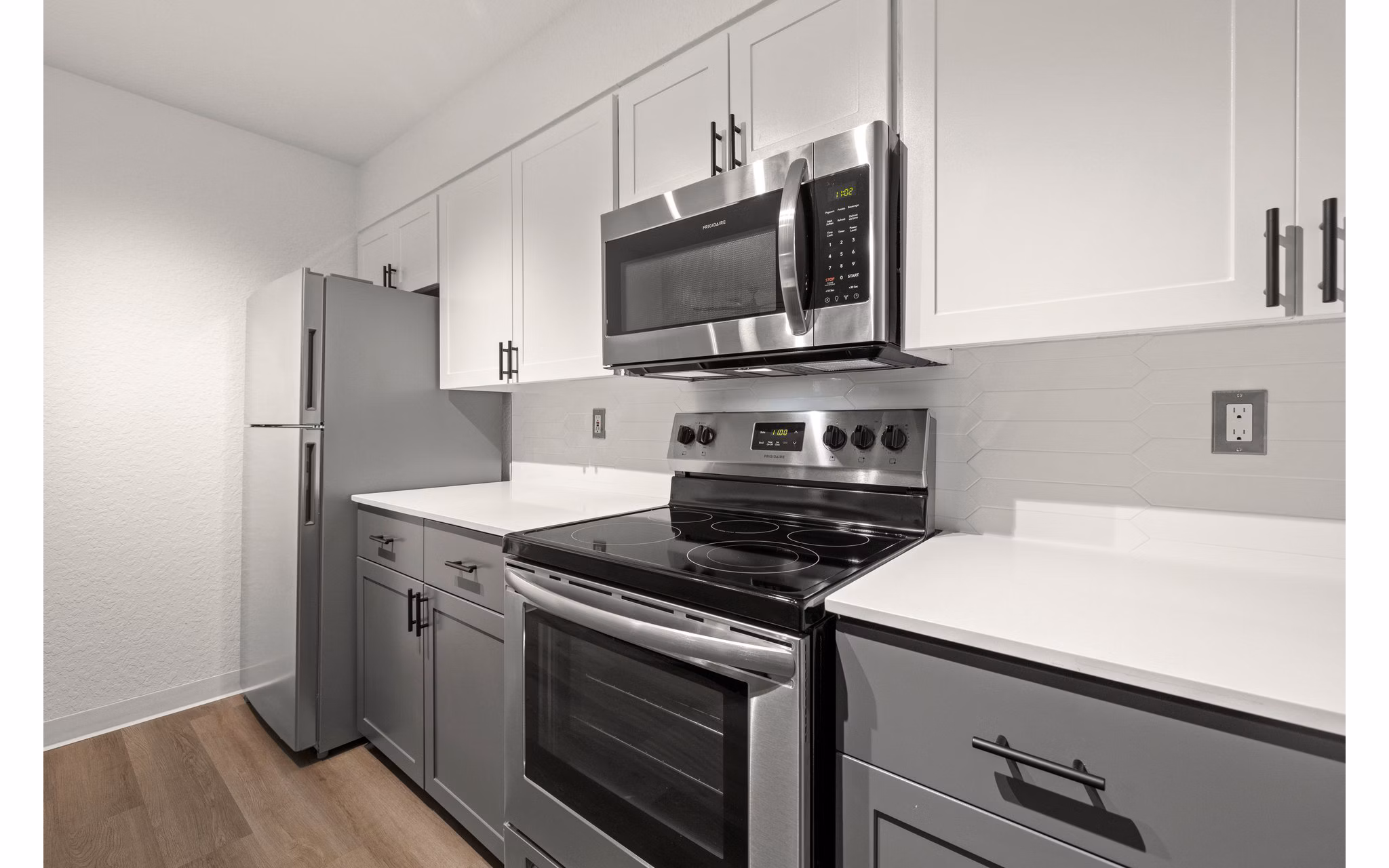 Modern kitchen with stainless steel appliances at Larkspur Place Apartments