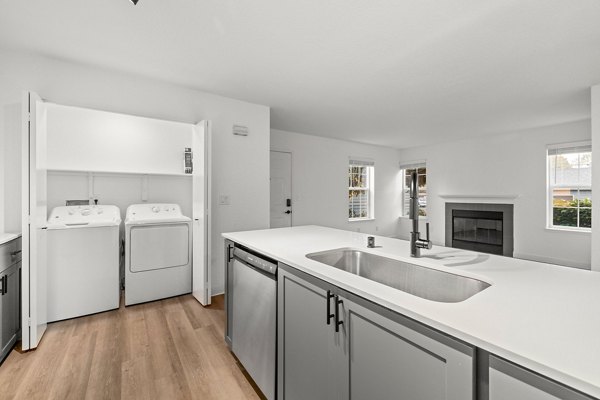 Modern kitchen with stainless steel appliances at Larkspur Place Apartments