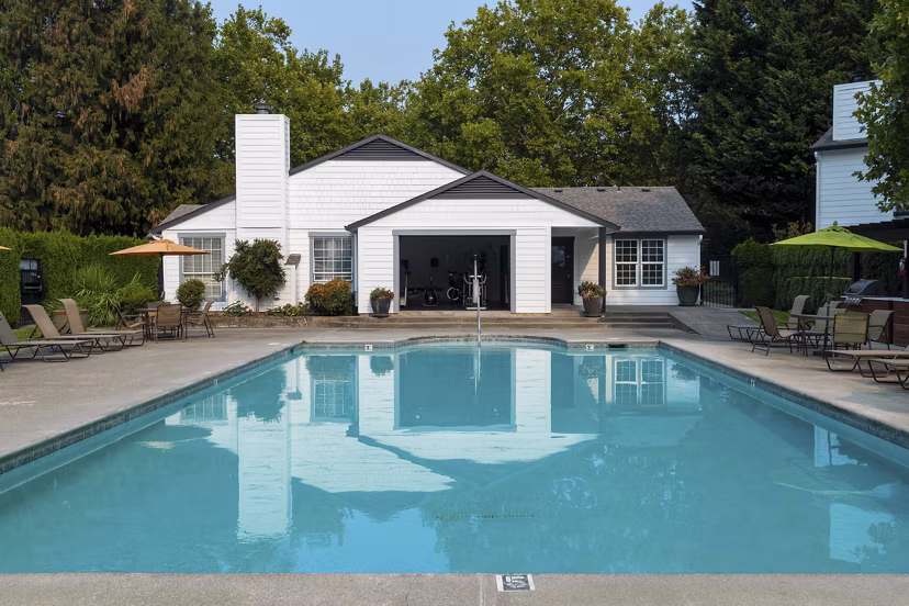 Resort-style pool with sun loungers at Sedona at Bridgecreek Apartments, offering relaxation and leisure in a luxury setting