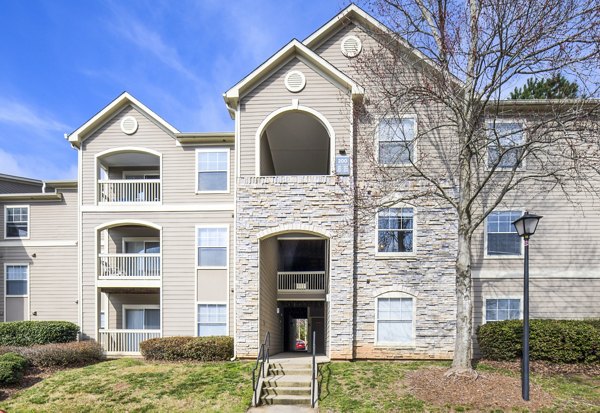 Luxury apartment building featuring balconies and a stone facade in a desirable location