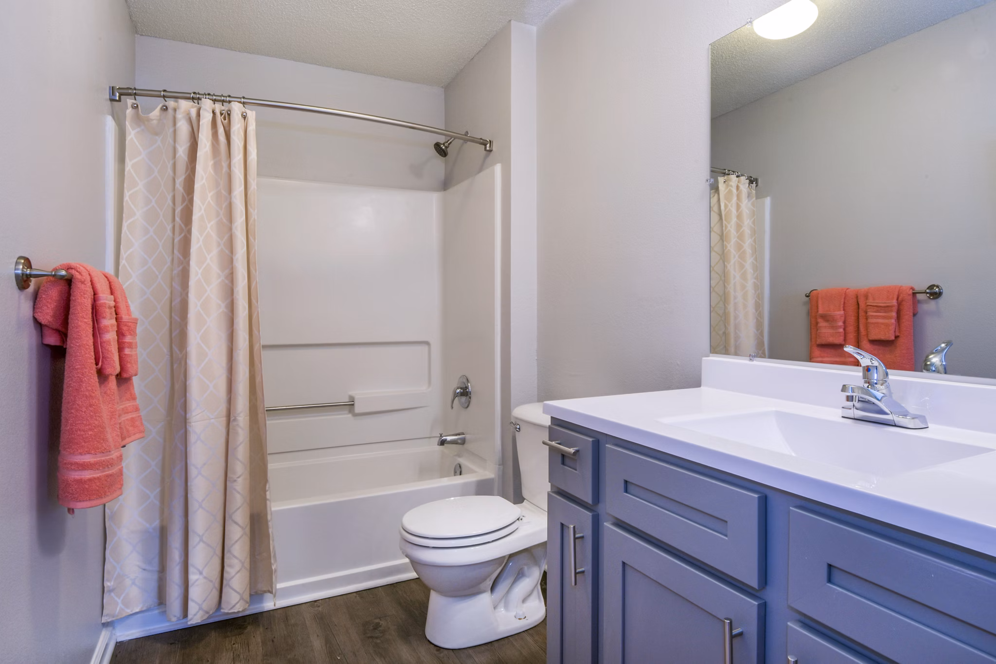 Luxurious bathroom featuring a soaking tub, modern shower, and stylish vanity in upscale luxury apartments