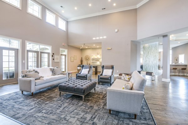 Spacious living room with modern furnishings and large windows in luxury apartments