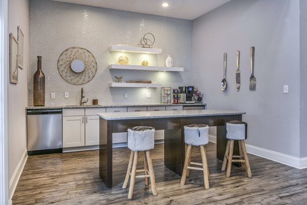 Modern kitchen with sleek countertops and stylish stools in luxury apartments