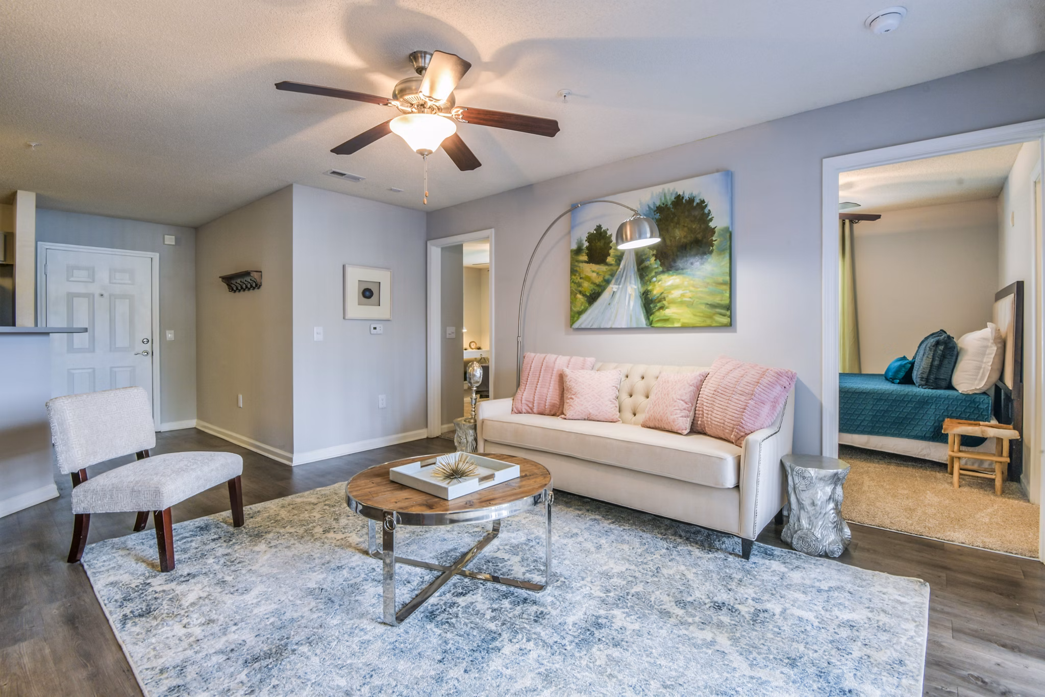 Cozy living room with a sofa, coffee table, and artwork in luxury apartment