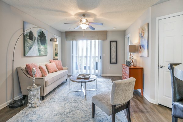 Modern living room featuring stylish sofa, chairs, and decor in luxury apartment