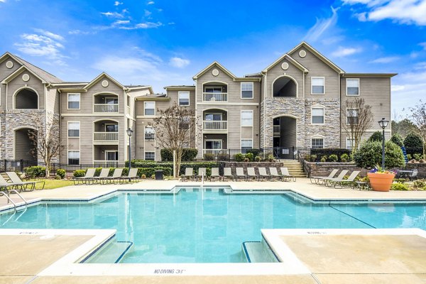 Luxury apartments with a swimming pool in front at the Greystar community