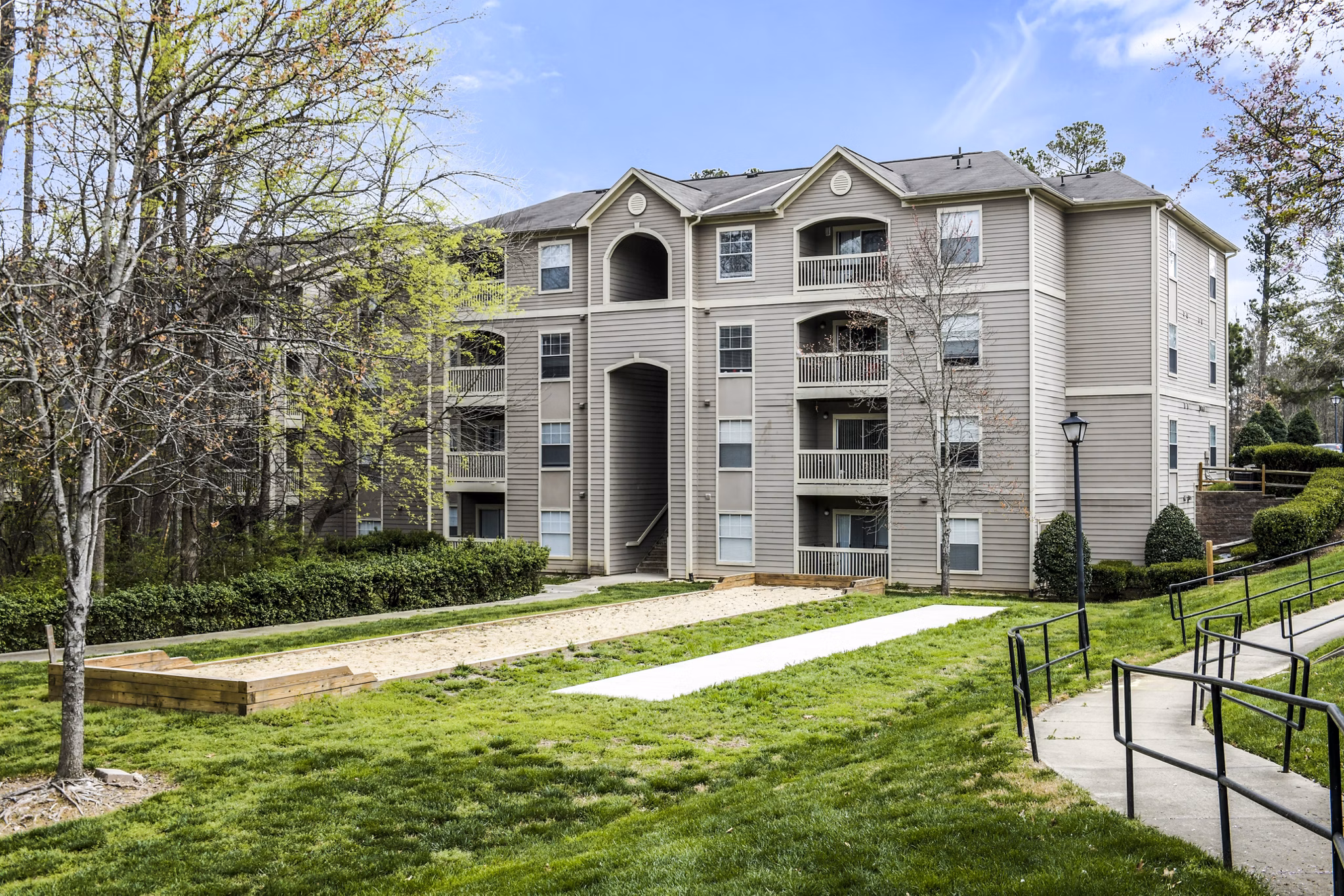 SkySite Images: Aerial view of luxury apartments in Raleigh, NC, showcasing modern architecture and surrounding landscape