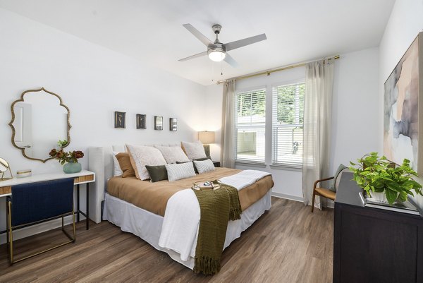 Cozy bedroom with modern decor and ample natural light at Overture Tributary Apartments