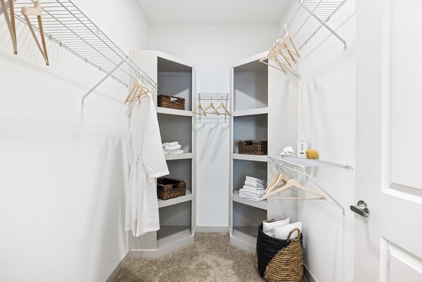 Interior closet featuring ample shelving and storage solutions in Overture Tributary Apartments Perfect for organizing personal belongings efficiently