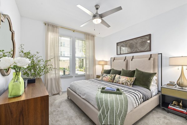 Bedroom with elegant furnishings and cozy decor at Overture Tributary Apartments, a luxury community by Greystar