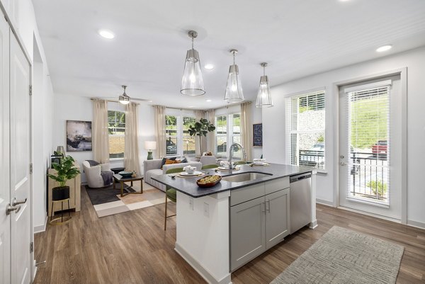 Modern kitchen with sleek countertops and stainless steel appliances in Overture Tributary Apartments