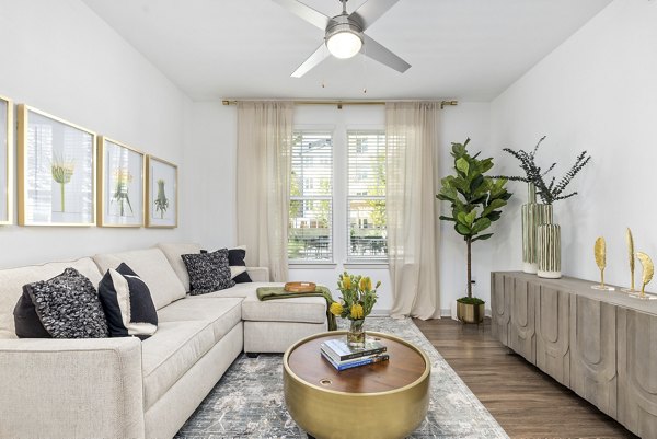 Spacious living room with modern decor and large windows in Overture Tributary Apartments