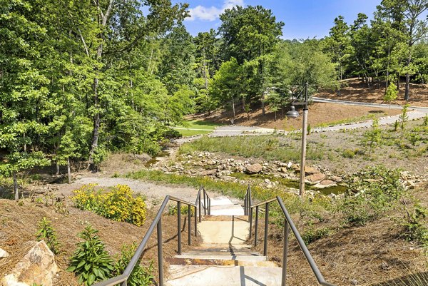Overture Tributary Apartments: Serene courtyard with manicured gardens and seating areas for relaxation