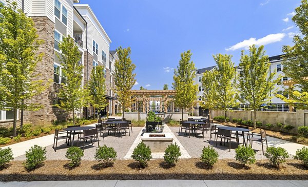 Peaceful courtyard with lush gardens at Overture Tributary Apartments, luxury living by Greystar