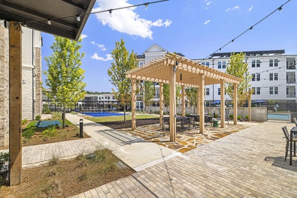 Tranquil courtyard garden with seating at Overture Tributary Apartments