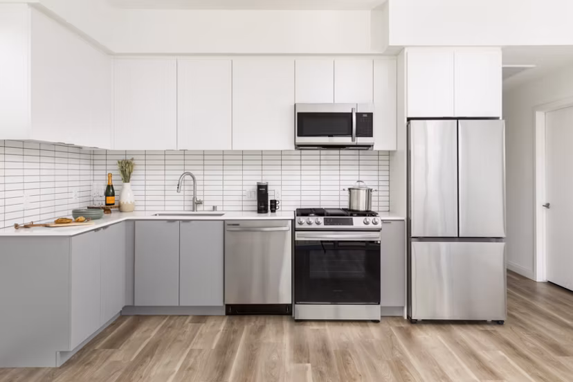 Modern kitchen with stainless steel appliances at The Charlie SM C&B Apartments luxury apartments