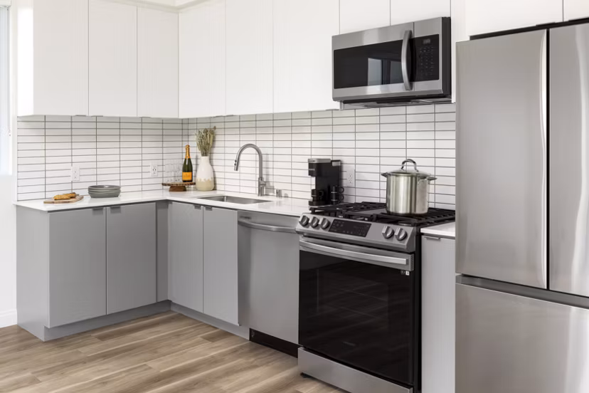 Modern kitchen featuring stainless steel appliances at The Charlie SM C&B Apartments