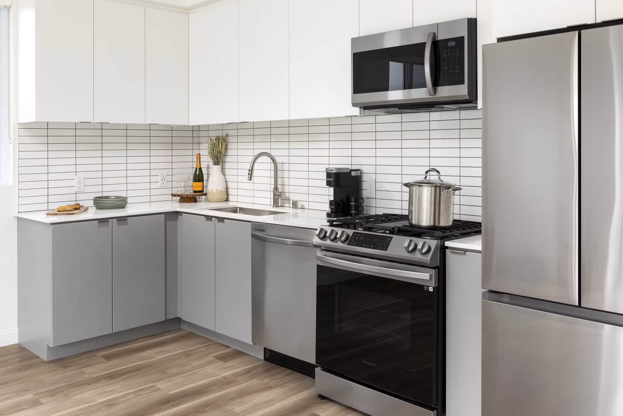 Modern kitchen featuring stainless steel appliances at The Charlie SM C&B Apartments