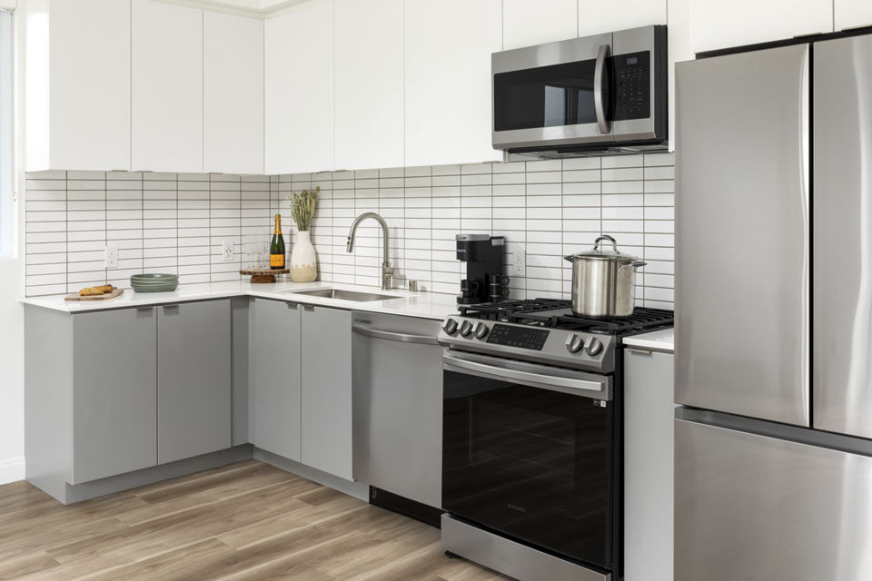 Modern kitchen featuring stainless steel appliances at The Charlie SM C&B Apartments