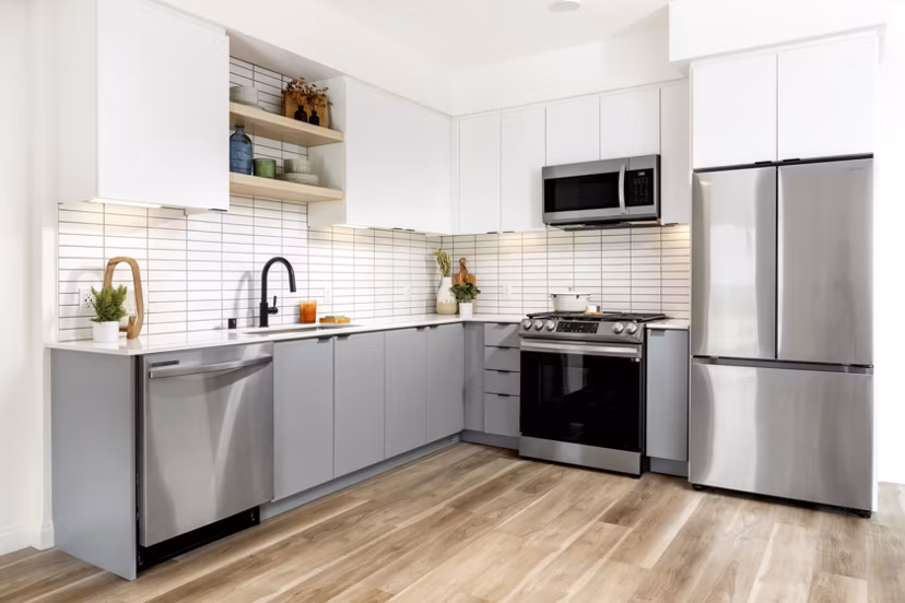 Modern kitchen with stainless steel appliances at The Charlie SM C&B Apartments