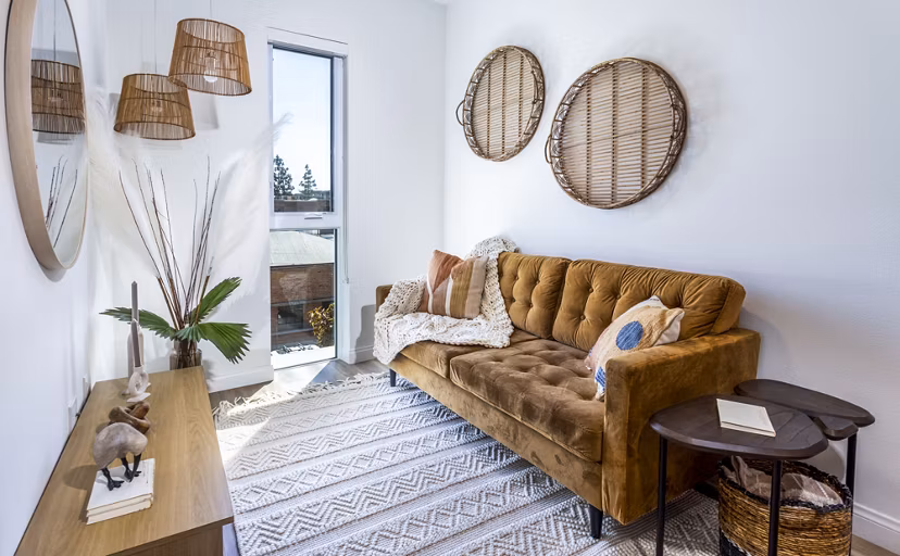 Spacious living room with modern decor and ample natural light at The Charlie SM C&B Apartments