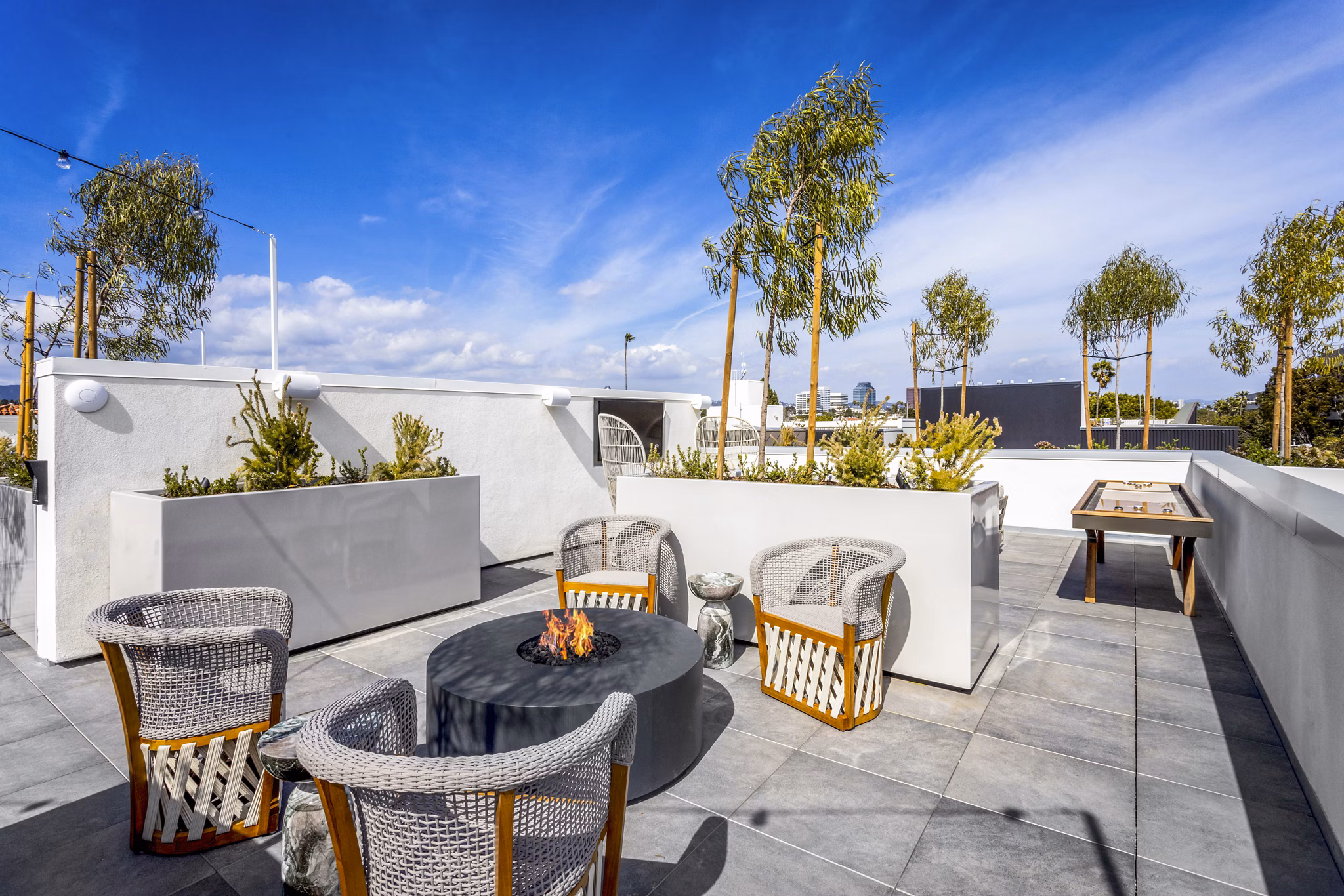 Game room and patio with stylish furnishings at The Charlie SM C&B Apartments, perfect for luxury living and entertaining