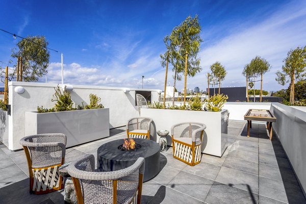 Game room and patio with stylish furnishings at The Charlie SM C&B Apartments, perfect for luxury living and entertaining