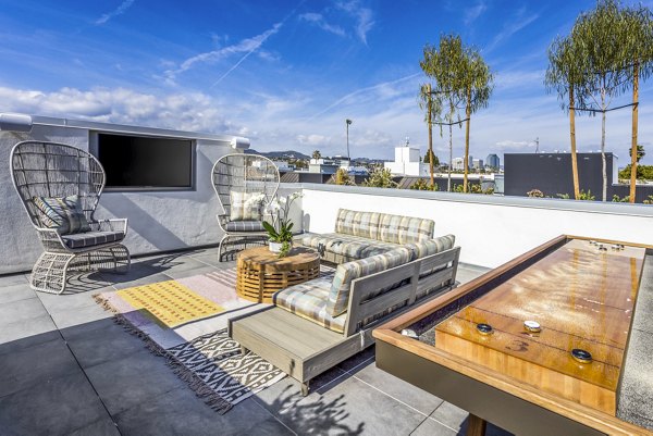 Game room and patio area at The Charlie SM C&B Apartments featuring luxury entertainment and relaxation spaces