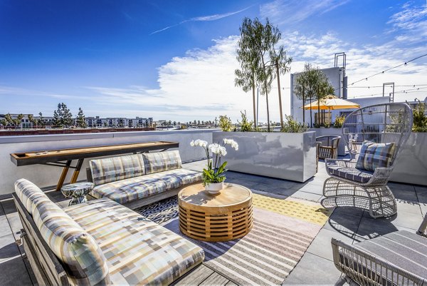 Game room and outdoor patio at The Charlie SM C&B Apartments featuring luxury amenities