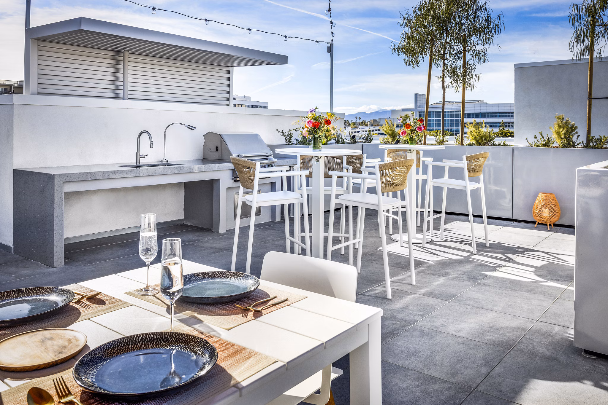 Grill and patio area at The Charlie SM C&B Apartments featuring outdoor seating and modern barbecue station