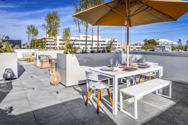 Grill area at The Charlie SM C&B Apartments featuring modern patio seating and amenities for outdoor gatherings