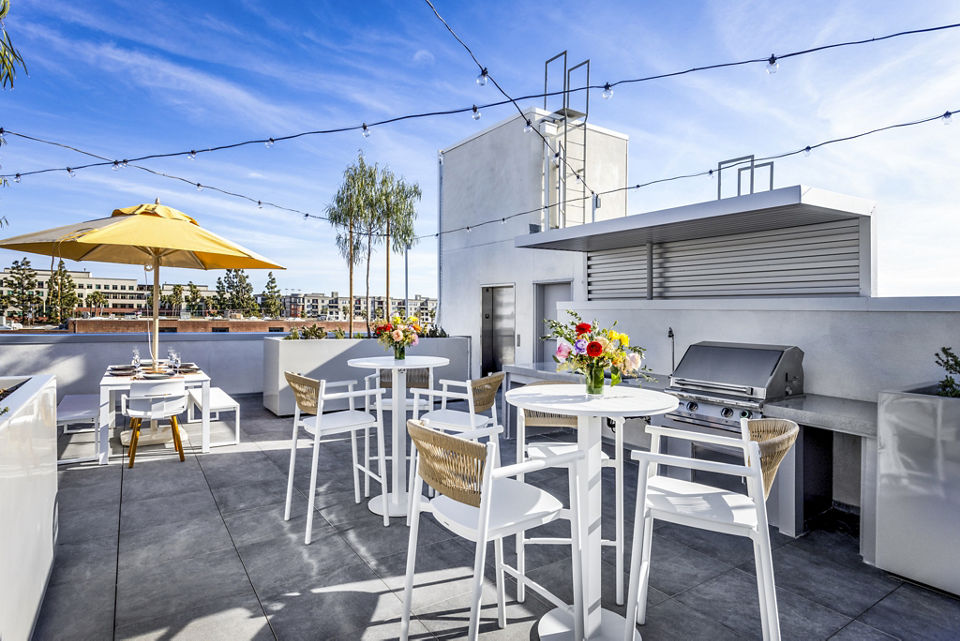 Spacious grill area on a stylish patio at The Charlie SM C&B Apartments, ideal for outdoor gatherings and dining