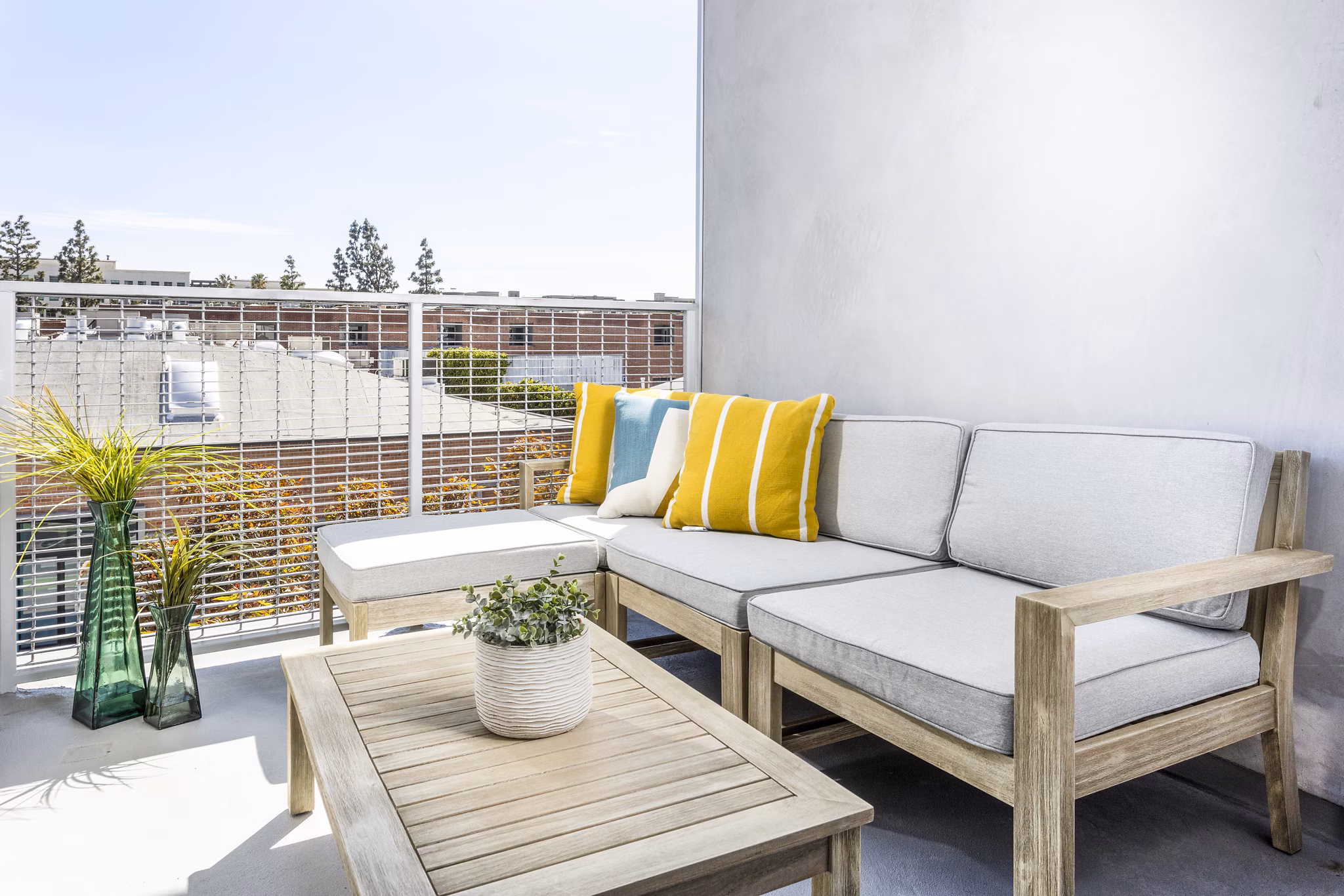 Spacious patio with modern furniture at The Charlie SM C&B Apartments, perfect for outdoor relaxation and dining