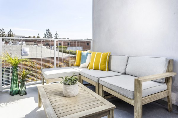 Spacious patio with modern furniture at The Charlie SM C&B Apartments, perfect for outdoor relaxation and dining