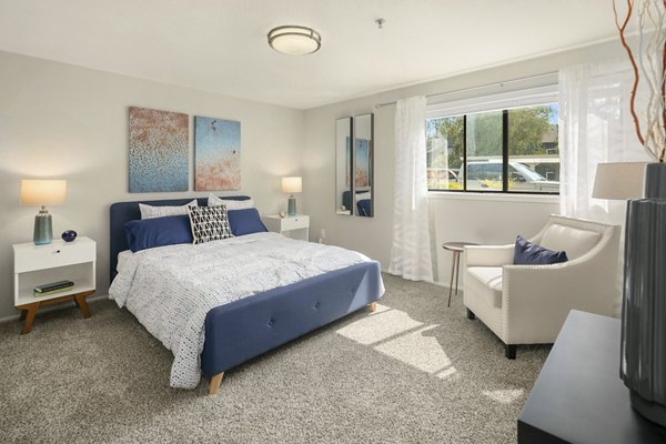 Cozy bedroom with modern decor at Skyview 3322 Apartments featuring plush bedding and ambient lighting