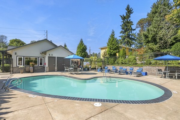 Relaxing pool area at Skyview 3322 Apartments with lounge chairs and lush greenery, ideal for leisure and rejuvenation