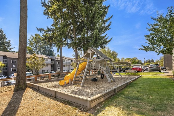Outdoor playground at Skyview 3322 Apartments featuring colorful slides and climbing structures for family-friendly recreation