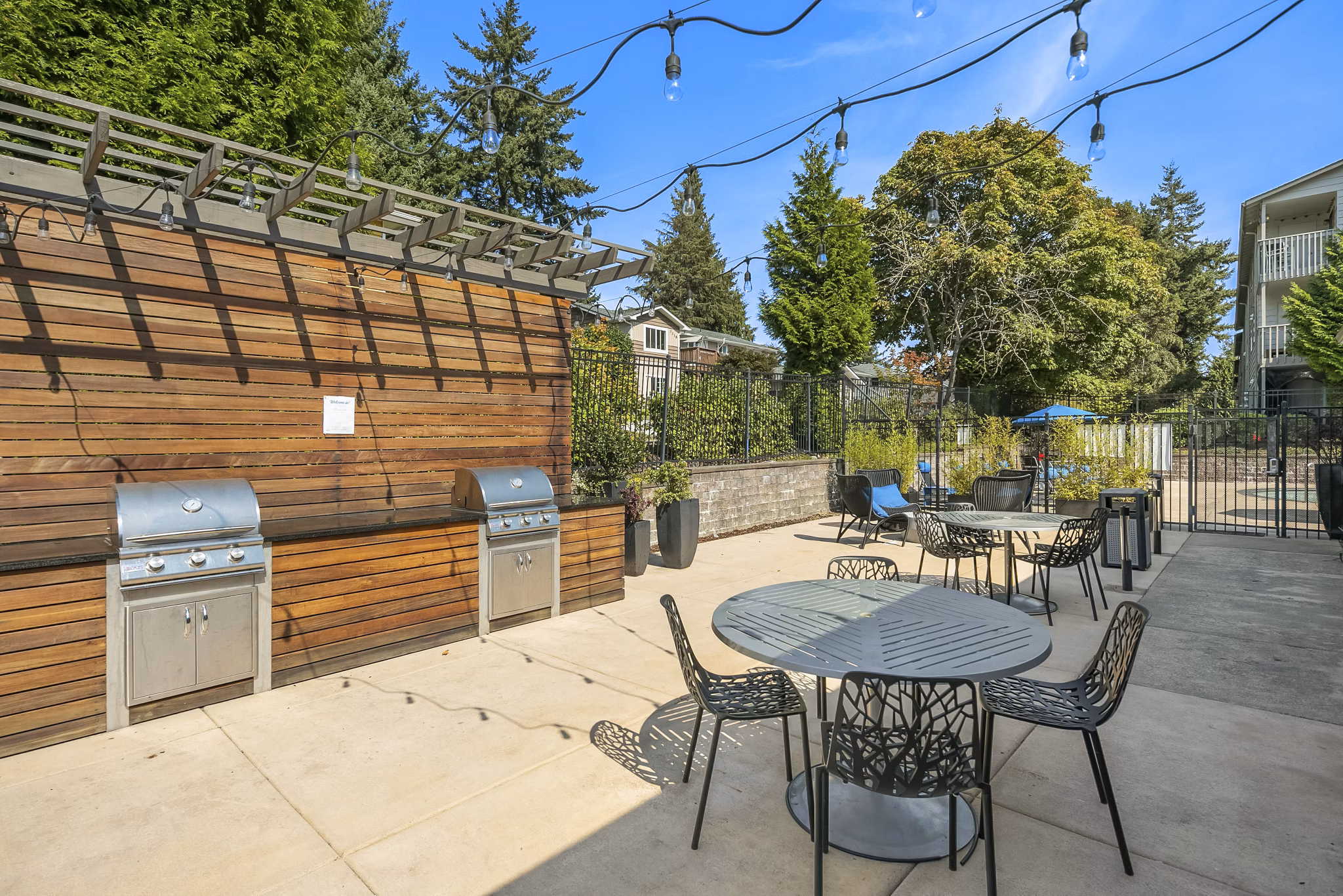 Outdoor grill area with modern seating at Skyview 3322 Apartments, perfect for social gatherings and alfresco dining