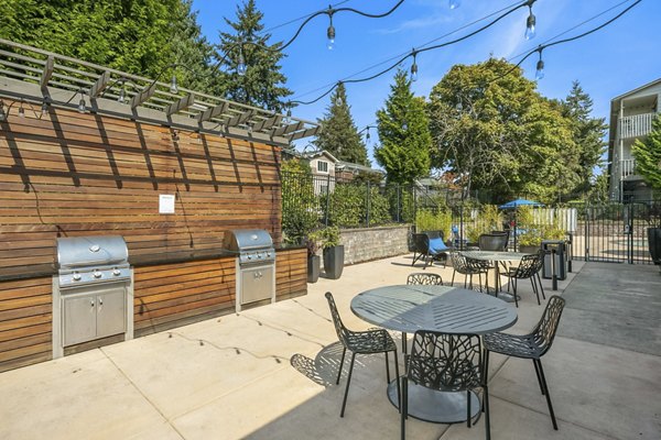 Outdoor grill area with modern seating at Skyview 3322 Apartments, perfect for social gatherings and alfresco dining