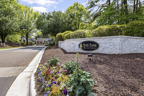 Signage at North Forest Apartments: Modern entrance sign with lush landscaping capturing the essence of luxury living in a serene setting