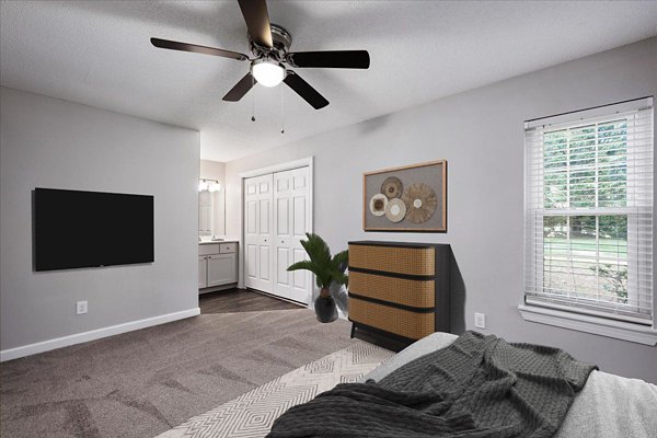 Cozy bedroom with modern furnishings at North Forest Apartments, featuring luxury living by Greystar