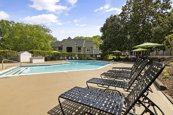 Poolside relaxation at North Forest Apartments, featuring luxury sun loungers and sparkling blue water