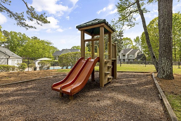 Modern playground with slides and swings at North Forest Apartments, ideal for family living and recreation