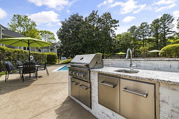 Outdoor grill area with modern seating at North Forest Apartments