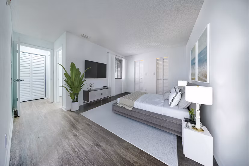 Bedroom with contemporary decor and large window in Cielo Point Apartments